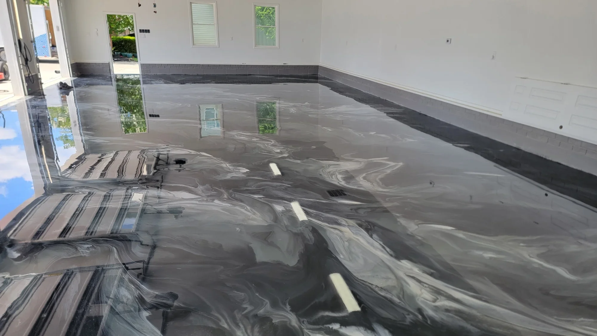 Gray epoxy floor coating with black stripe detail in commercial space