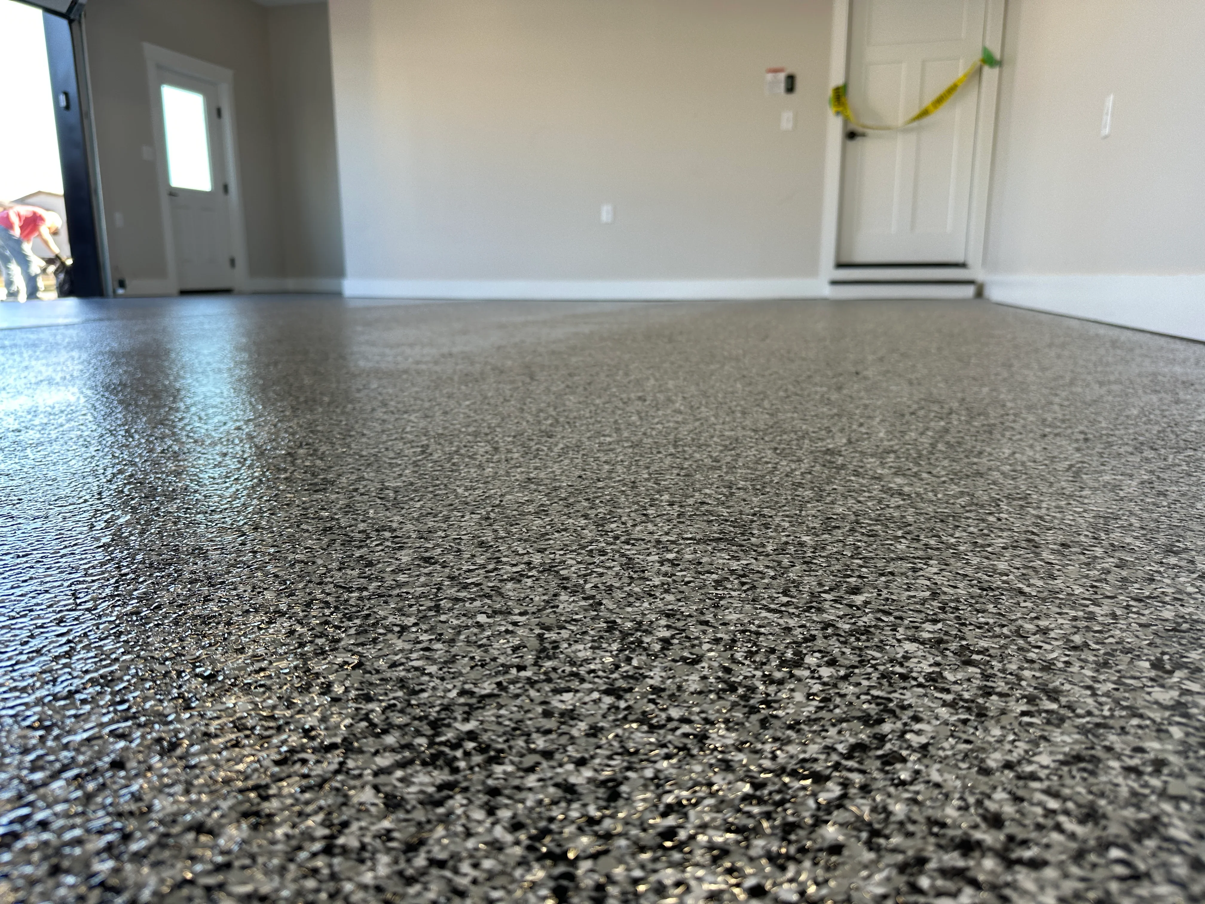 Polished concrete floor with dark aggregate and glossy seal in finished interior space