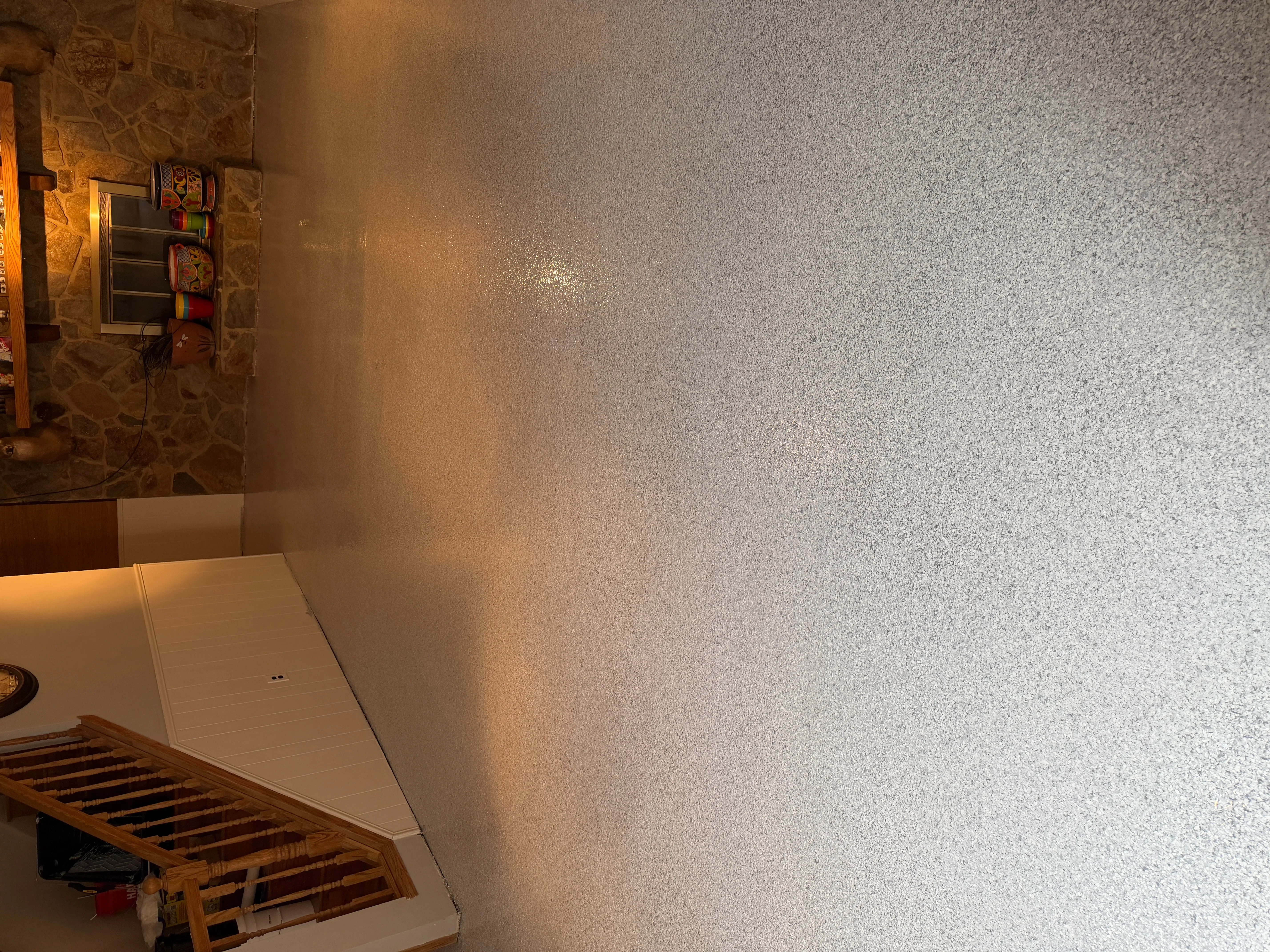 Light gray epoxy-coated garage floor with speckled finish and clean appearance