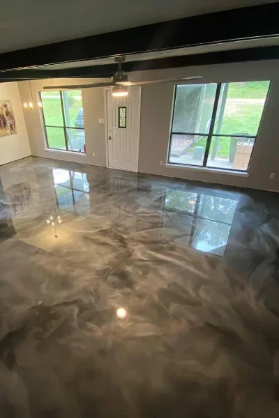 Metallic epoxy concrete floor with gray and bronze swirl pattern, high-gloss finish reflecting light