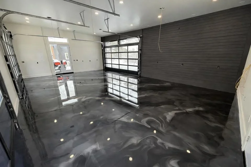 Dark gray epoxy garage floor with metallic swirl finish and reflective sheen