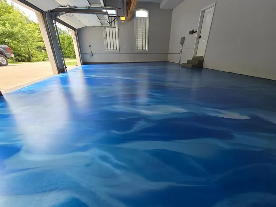 Blue epoxy garage floor with flake finish, high-gloss coating, residential garage interior
