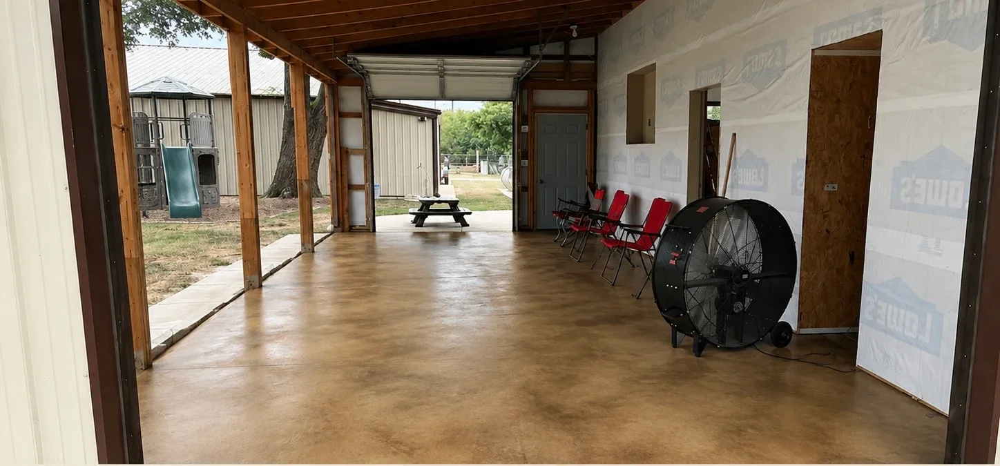 Polished concrete floor with amber finish in open event space with wooden beams
